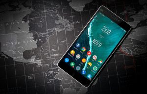 Smartphone on world map background