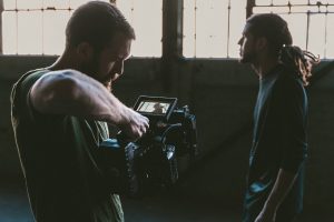 Cameraman and cast member filming a video